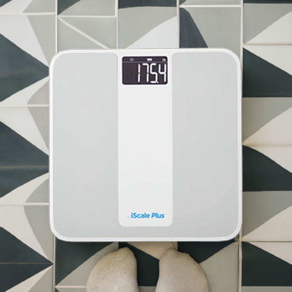 Top view of the Smart Meter iScale weight scale on a geometric bathroom tile floor, showcasing its sleek design